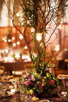 the table is set with flowers and candles for an elegant dinnereonal style setting