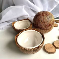 two coconuts and some coins on a table