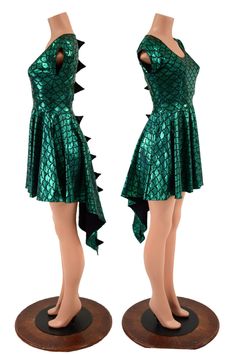 two mannequins dressed in green dresses with spikes on their backs and legs