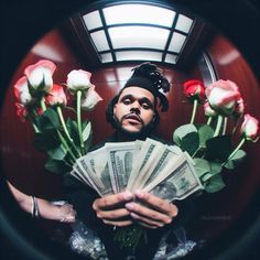 a man holding roses and money in his hands