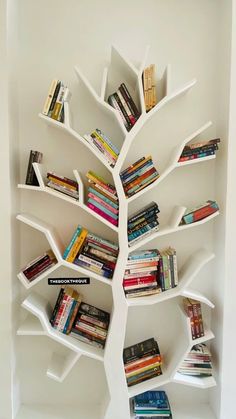 a white book shelf filled with lots of books