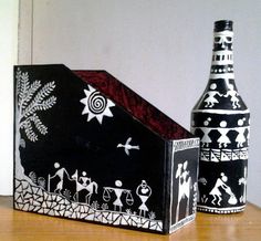 two black and white vases sitting on top of a table next to a bottle