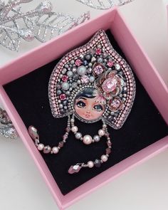 a pink box with a necklace in it