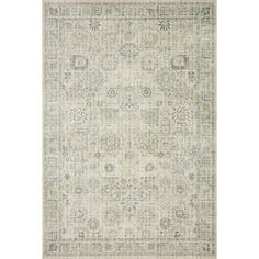 an area rug with various colors and patterns on the floor, including white and gray