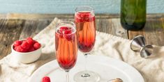 two glasses of raspberry champagne on a white plate