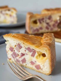 a piece of ham and cheese pie on a plate with a fork