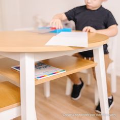 a young boy sitting at a wooden table