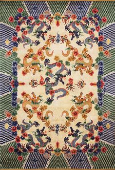 an intricately designed rug with dragon and flower designs on it's border,