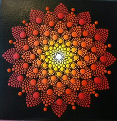 an abstract painting with orange and yellow dots on black paper, in the shape of a flower