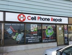 a cell phone repair store with signs on the windows