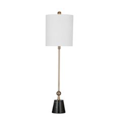 a black and gold lamp with a white shade