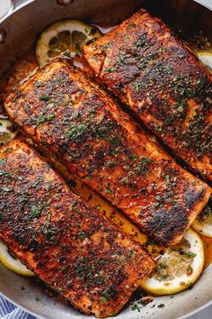 grilled salmon with lemons and herbs in a pan