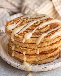 a stack of pancakes covered in icing on a plate