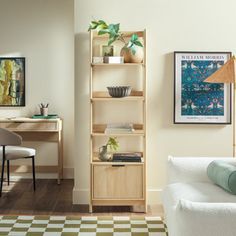 a living room filled with furniture and a white couch next to a desk on top of a hard wood floor