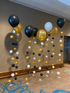 balloons and streamers are hanging from the wall in an office lobby with carpeting