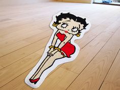 a sticker depicting a woman in a red dress sitting on the floor with her legs crossed