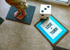 a child's feet and dice on the floor next to a sign that says, lose a turn