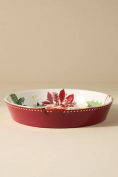 a red and white bowl sitting on top of a table