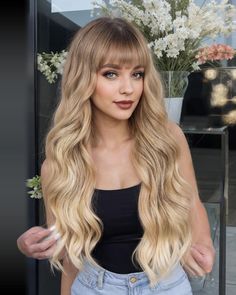 PRICES MAY VARY. 1.【Wig Style】This long wavy wig with bangs is a charming and fashionable hairstyle.Natural waves and look, realistic bangs, make the wig look more real and cute. You can freely trim and shape your bangs into various styles, making you more charming, confident and stunning, and it will provide you with more surprises. 2.【High Quality Material】This long wavy wig is made of 100% heat-resistant high-quality synthetic fiber. And has heat up to 160°C (320°F). Easy to comb, not prone t Blonde Colors, 2000s Hairstyles, Bangs For Women, Blonde Wigs, Wavy Wigs, Wigs Synthetic, Dark Blonde Hair, Wavy Wig, High Quality Wigs