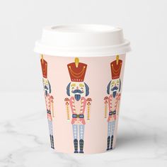 a paper cup with an image of nutcrackers on the front and sides