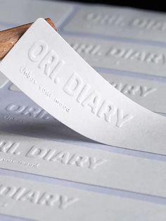 a close up of a rubber stamp on some white paper with a wooden stick sticking out of it