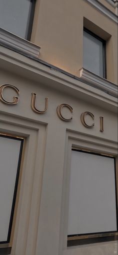 a building with the word gucci written on it's front and side windows