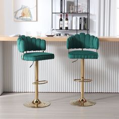 two green velvet bar stools in front of a counter