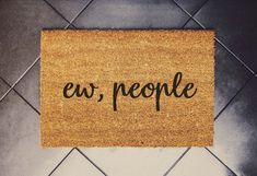 a door mat with the word ew people written on it next to a tiled floor