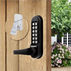 an electronic door lock on a wooden fence