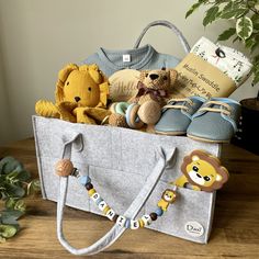 a basket filled with stuffed animals sitting on top of a wooden table next to a potted plant