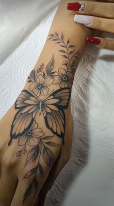 a woman's hand with flowers on it