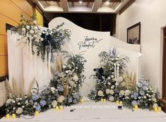 a table with flowers and candles on it in front of a sign that says happy anniversary