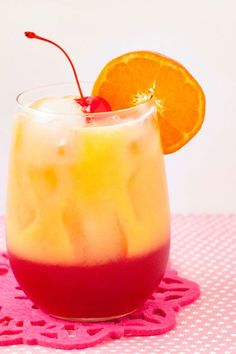 a drink in a glass with an orange slice on the rim