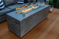 an outdoor fire pit sitting on top of a hard wood floor next to a couch