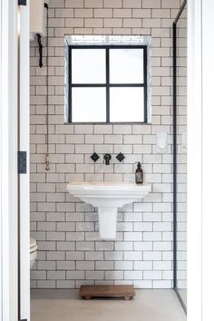 Black taps wall mounted in a small monochrome bathroom with Landmark LMK Industrial fixtures. Black Chrome Bathroom, Brass Bathroom Fixtures