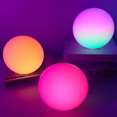 two glowing balls sitting on top of a box