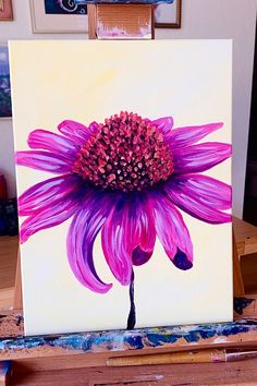 a painting of a purple flower on a easel