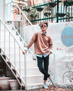 a man standing next to a set of stairs