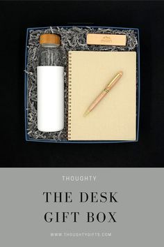 the desk gift box includes a notepad, pen, and glass bottle with cork top