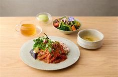 a table topped with plates and bowls filled with food