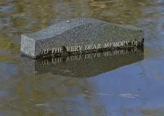 a memorial stone in the middle of a body of water that reads, to the very dear memory of 10 lake drive victoria