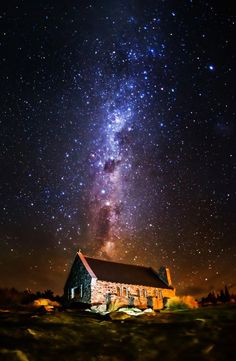 the milky is shining brightly over an old church