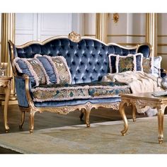 an ornately decorated living room with blue and gold furniture