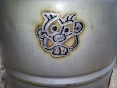 a close up of a trash can with graffiti on it