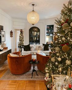 a living room filled with furniture and a christmas tree