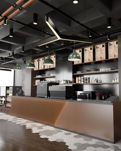 the interior of a coffee shop with lots of counter space and hanging lights above it