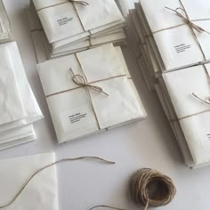 several white packages tied up with twine and some brown string on the floor next to them