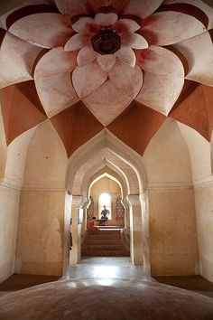 the inside of an ornate building with a large flower on it's center piece