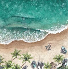 an aerial view of a beach with boats and palm trees