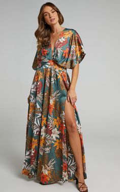 We’re getting big vacay vibes from the Vacay Ready Maxi Dress! This sexy A-line maxi features a plunging neckline, an open keyhole back and a thigh-high split on both sides. It’s such a comfortable piece to slip on in the warmer months and can easily be dressed up or down. Pair it with sandals and a shoulder bag for an easy casual look or dress it up with strappy heels, a fine chain necklace and earrings!Product DetailsInvisible zipper on the centre backLoose elbow-length sleevesFitted waistband Thigh Split Dress, Split Dress Thigh, Split Dress, Dress Plus Size, Floral Maxi, Latest Fashion For Women, Floral Maxi Dress, Guest Dresses, Plus Size Dresses